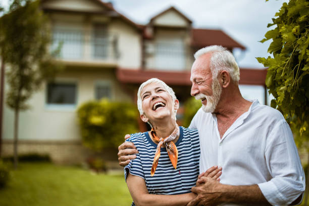 istock Embraced senior couple talking about something funny in the backyard. 1393576510