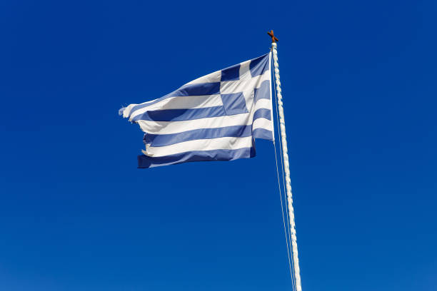 istock Greek flag on the blue sky background. 1393577730