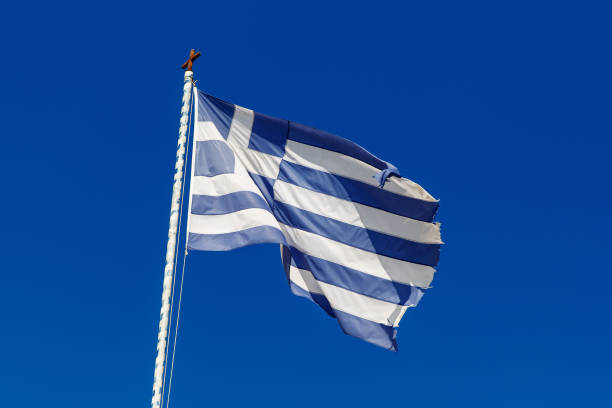 istock Greek flag on the blue sky background. 1393577739