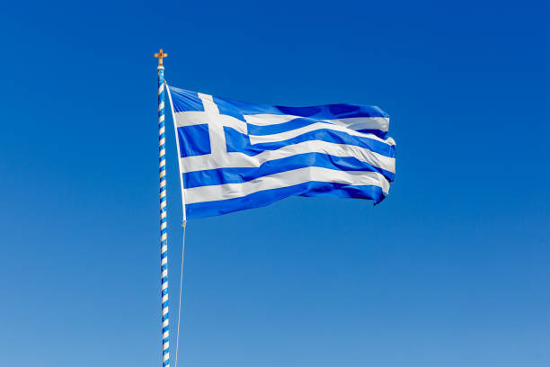 istock Greek flag waving against the blue sky. 1393577832