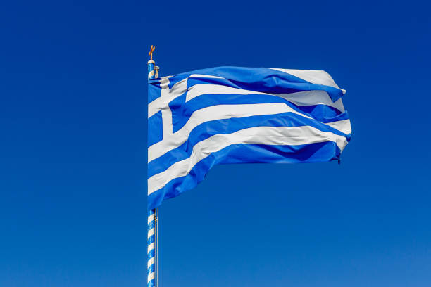 istock Greek flag waving against the blue sky. 1393577839
