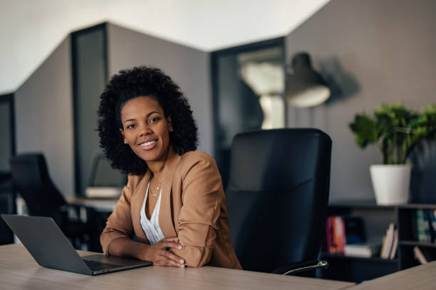 istock Smiling African woman, looking at the camera, dressed elegantly. 1393580286