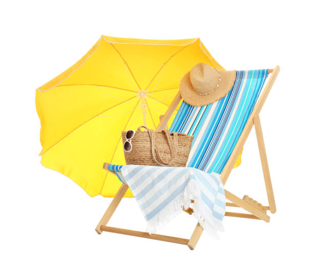 istock Open yellow beach umbrella, deck chair and accessories on white background 1393580732