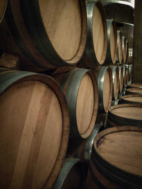 istock wooden barrels stacked in a row 1393581158