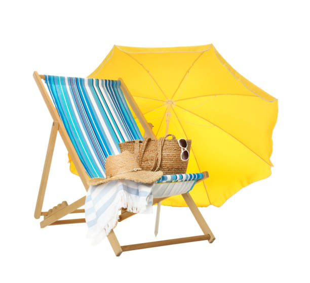 istock Open yellow beach umbrella, deck chair and accessories on white background 1393581959