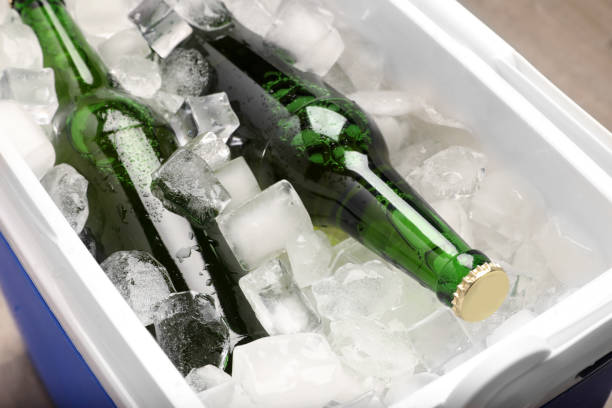 istock Plastic cool box with ice cubes and beer, closeup 1393581987
