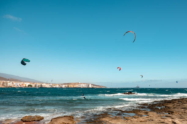 Kite-surfing and a lot of silhouettes of kites in the sky. Holidays on nature. Artistic picture. Beauty world.