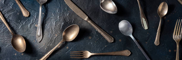 istock Cutlery panorama. Various forks, knives, and spoons, elegant silverware 1393585016