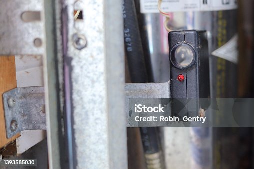 istock Close up of a garage door photo eye sensor 1393585030