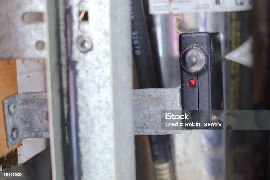 Close up of a garage door photo eye sensor Garage Stock Photo