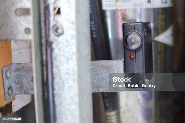 Close Up Of A Garage Door Photo Eye Sensor Stock Photo - Download Image Now - Garage, Door, Sensor