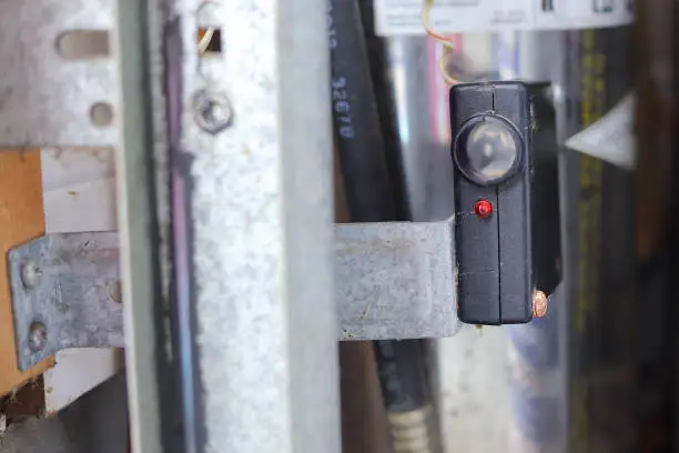 Photo of Close up of a garage door photo eye sensor