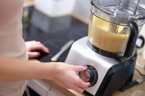 istock Woman adjusting speed of food processor closeup 1393585168
