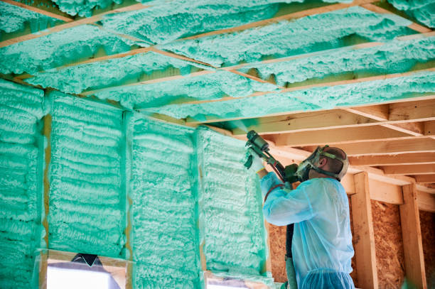 istock Worker spraying polyurethane foam for insulating wooden frame house. 1393586274