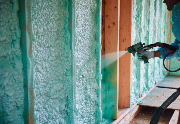istock Worker spraying polyurethane foam for insulating wooden frame house. 1393586336