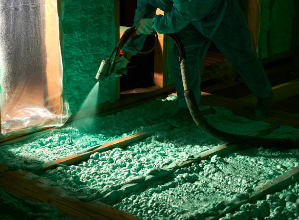 istock Worker spraying polyurethane foam for insulating wooden frame house. 1393586472