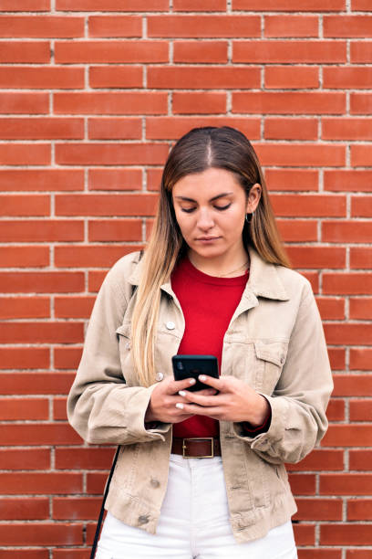 istock Young Beautiful Girl Using Phone 1393588129