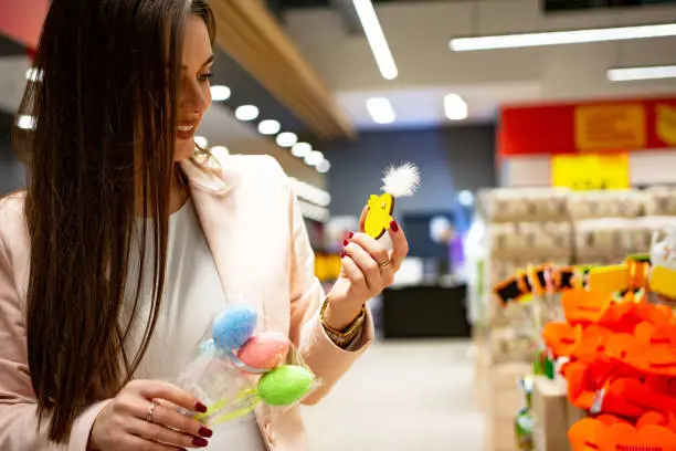 Photo of Young woman visiting supermarket food department for shopping