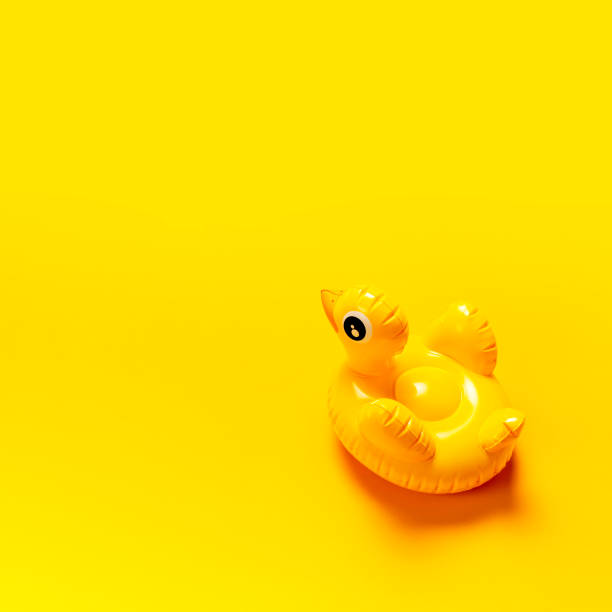 istock Creative summer beach concept. Inflatable mini yellow chicken or duckling on yellow background, pool float party. Flat lay copy space. Trend Inflatable Children toy for swimming. Layout for design 1393589169