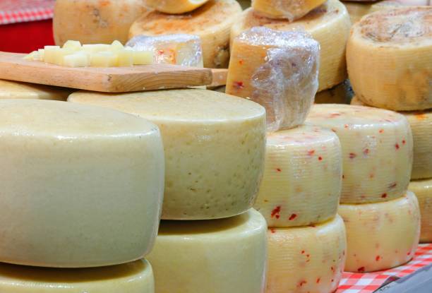 aged cheese and pecorino also with chilli pepper on sale in the dairy stall aged cheese and pecorino also with chilli pepper on sale in the dairy stall at the market pecorino romano stock pictures, royalty-free photos & images
