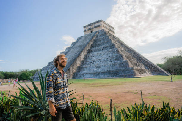 istock Man on the background of Chichen Itza pyramid in Mexico 1393591118