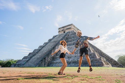 Young Caucasian  heterosexual couple on the  background of Chichen Itza pyramid in Mexico