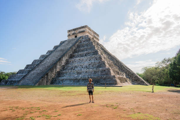 istock Man on the background of Chichen Itza pyramid in Mexico 1393591301