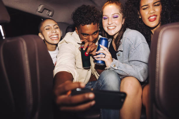 istock Friends taking a selfie inside a car at night 1393591766
