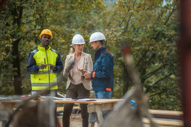 istock Female CEO Giving Feedback To Construction Workers 1393592046