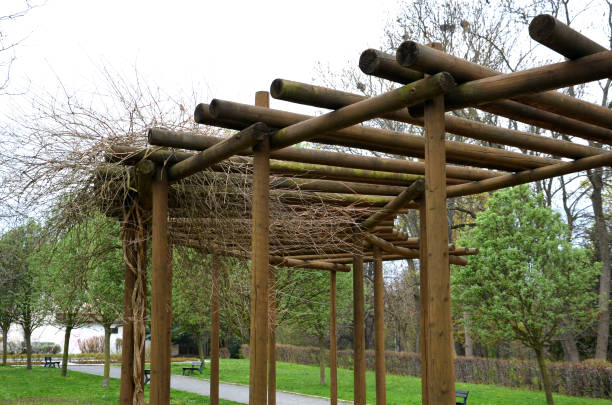 pérgola redonda, enrejados hechos de postes de madera alrededor del arenero con elementos de juego para niños. alrededor hay un camino y césped. bancos para que las mamás descansen. estacas al estilo chino japonés - outdoors store beach bench fotografías e imágenes de stock