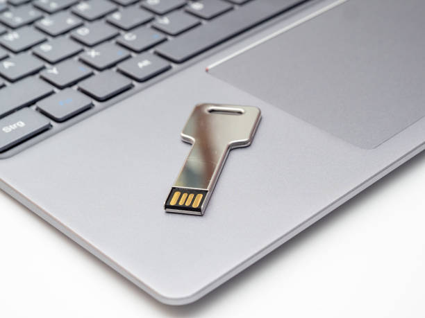 istock usb flash drive in the form of a key and a laptop. 1393600319