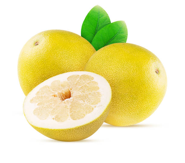 istock Two pamela citrus fruit one cut in half with green leaf 1393600419