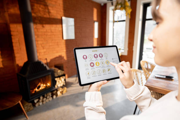 istock Woman controlling home devices remotely by using smart home app on digital tablet at home 1393601031