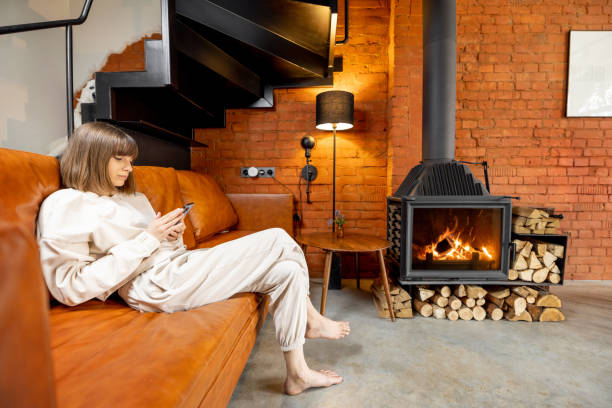 istock Woman sitting relaxed on a couch and using phone at home 1393602118