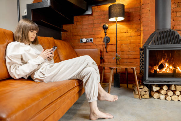 istock Woman sitting relaxed on a couch and using phone at home 1393602137
