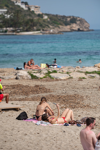 Ibiza, Spain : 2022 April 14 : People at Figueretas Beach on Ibiza Island in Spain in the summer of 2022.