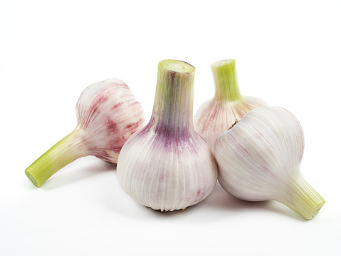 Garlic,rosemary and peppercorns on wooden background