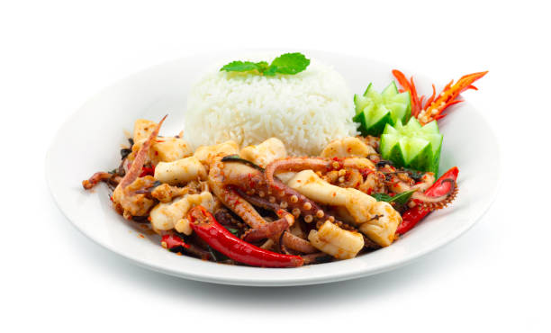 Stir Fried Tentacles and Squids Roe Spicy with Basil Served Rice stock photo