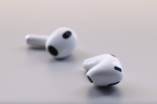 istock New white wireless earphones, on grey background 1393609371