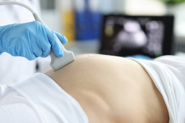 istock Gynecologist doing ultrasound scan on belly, pregnancy screening 1393609379