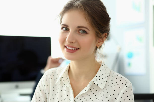istock Smiling woman posing in corporate modern office. 1393609406
