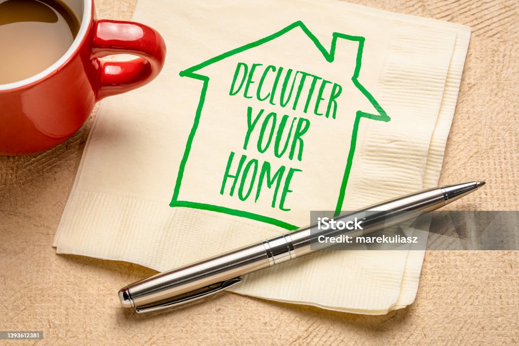 declutter your home declutter your home motivational reminder - handwriting and sketch on a napkin with a cup of coffee, simplicity and minimalism concept Decluttering Stock Photo