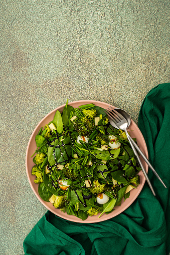 Salad with spinach and wild garlic, quail eggs and boiled broccoli, mozzarella and balsamic vinegar, healthy light salad