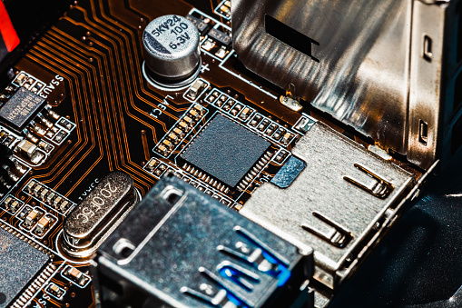 Close-up of a part of a computer electronic motherboard. Processor, chips and capacitors.