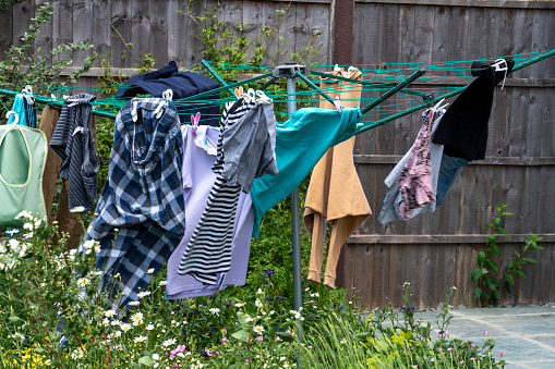 Washing left out on a windy day in an English country garden.  A slow shutter speed shows the movement in the wind.