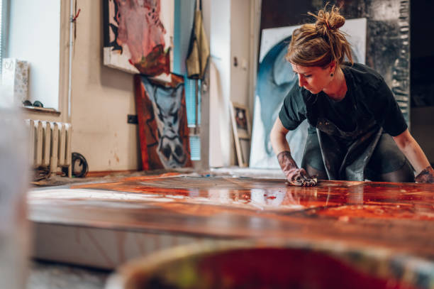 istock Female painter artist painting and creating her art in a creative studio 1393613093