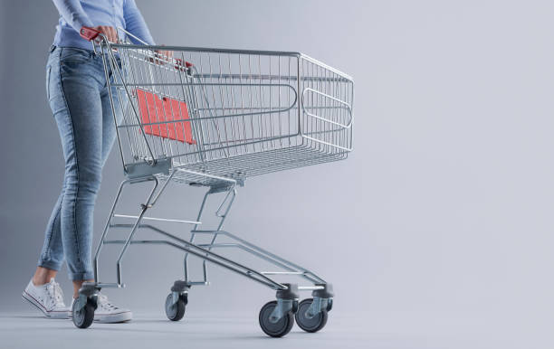 istock Woman pushing an empty shopping cart 1393614629