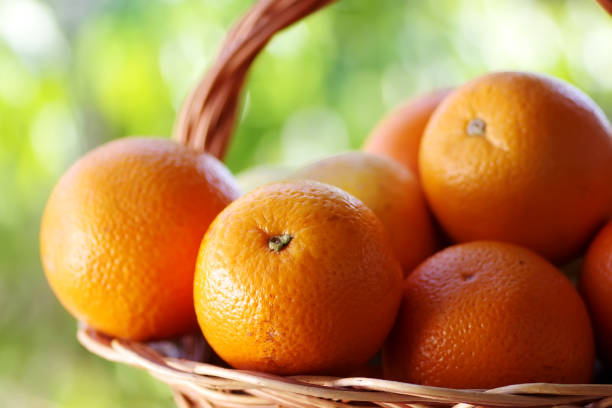 istock ripe oranges on wooden basket 1393615791