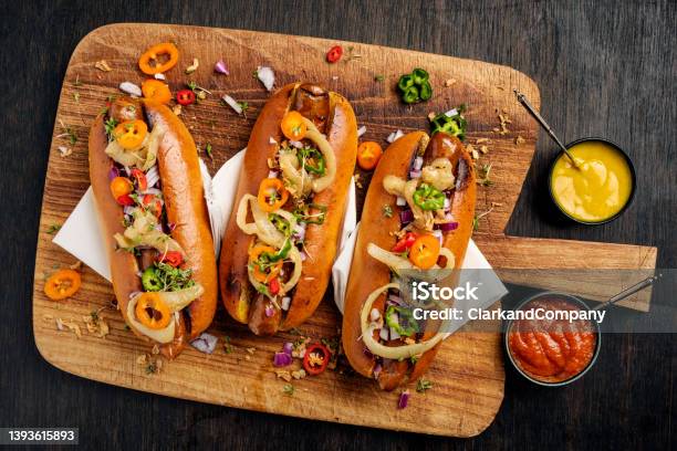 Artisan Hot Dogs In Brioche Rolls With Pickles Onion And Relishes Stock Photo - Download Image Now