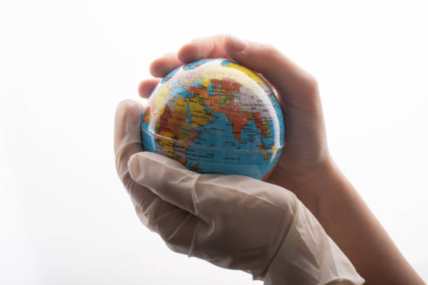 istock Hand with gloves holding globe  corona virus flu outbreak. 1393616066